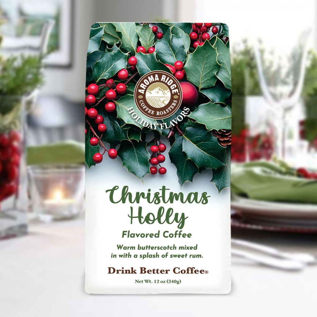 Aroma Ridge Christmas Holly flavored coffee package with holly berries and green leaves on a blurred holiday table setting.